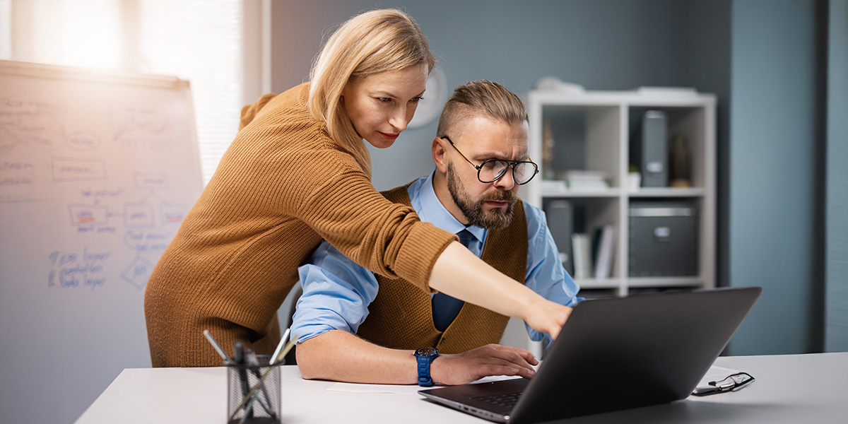 Two people in front of a computer